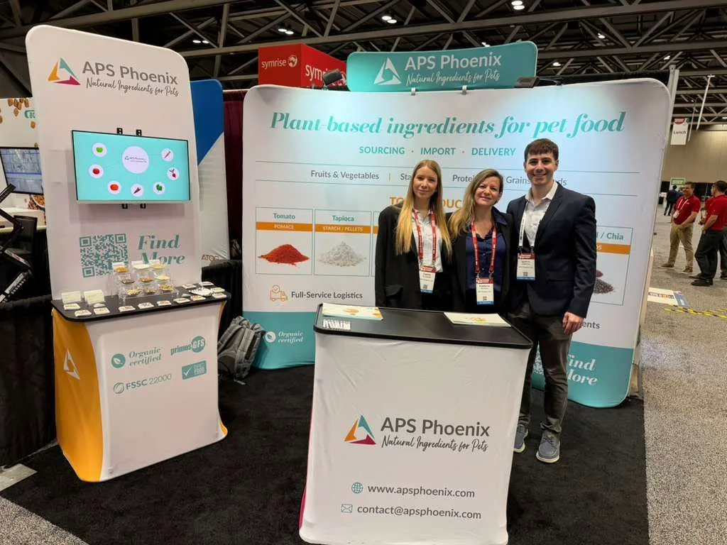 APS Phoenix team at Booth 1026 during Petfood Forum 2026, Kansas City Convention Center, with neighbouring exhibitors visible.