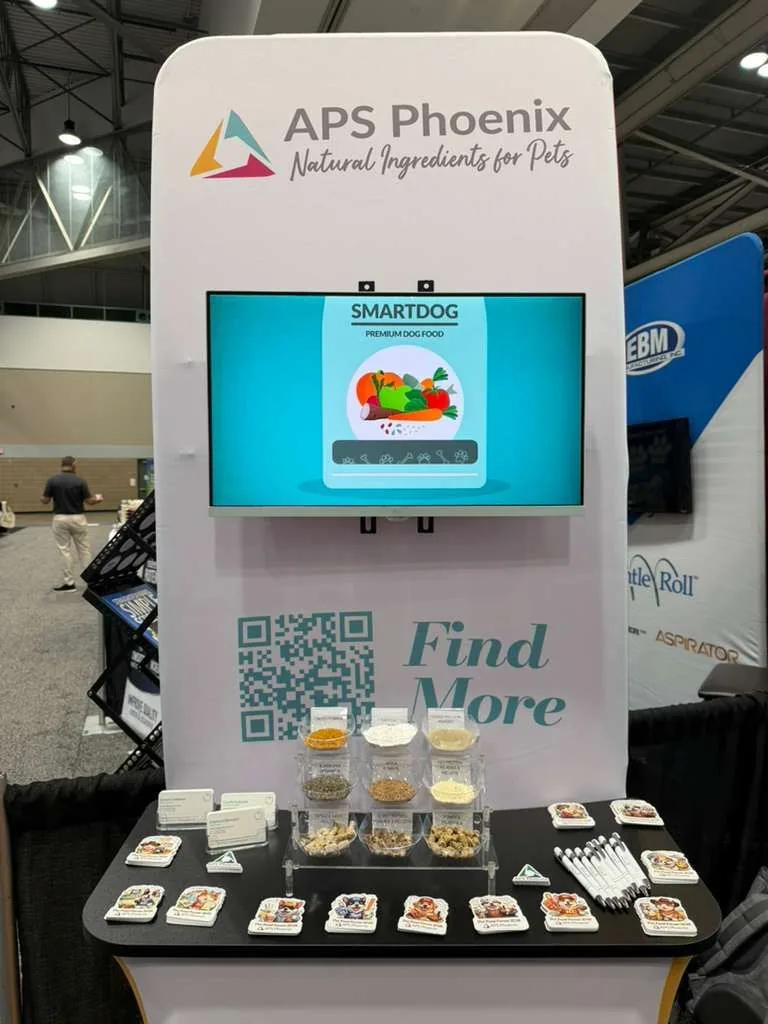 APS Phoenix booth tower with SMARTDOG screen and branded swag at Booth 1026, Petfood Forum 2026, Kansas City Convention Center.